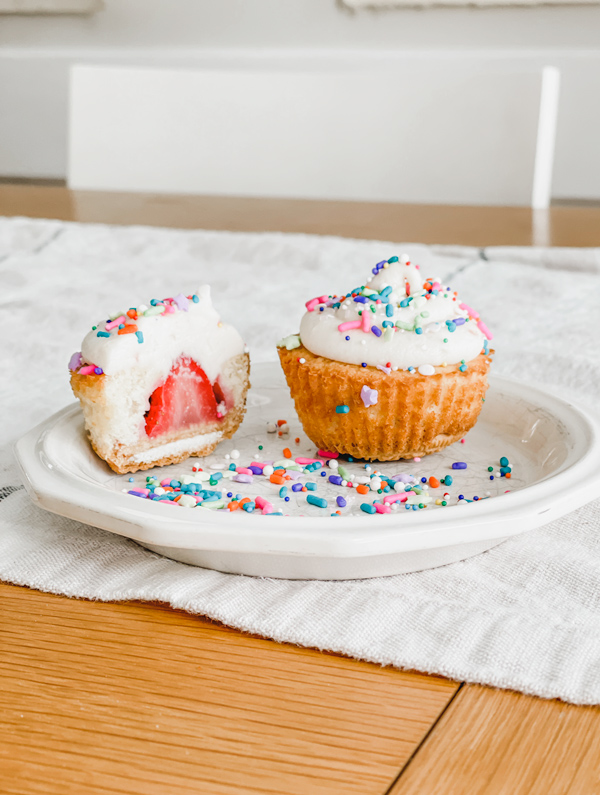 strawberry cupcake with sprinkles on a plate